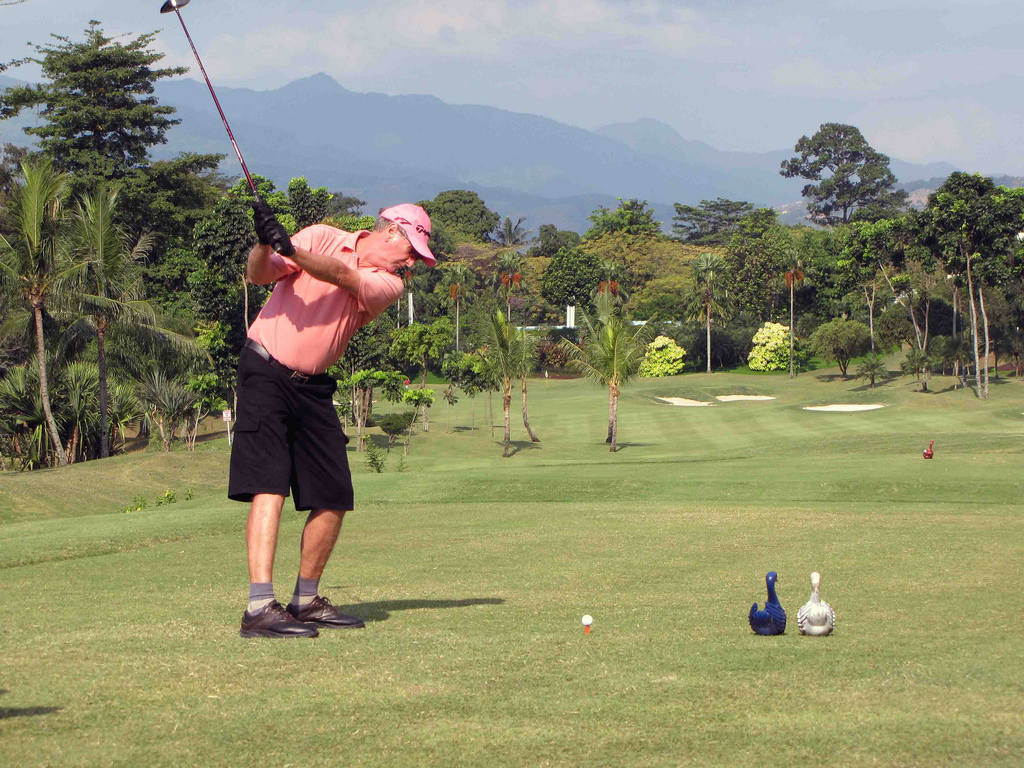 Golfer teeing off