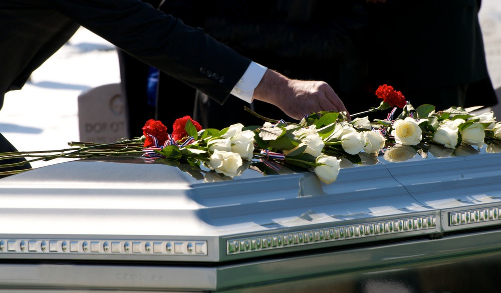 mourner-placing-flower-on-casket-arlington