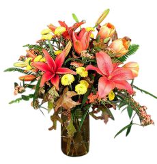 Southern hospitality bouquet of orange lilies, orange tulips and yellow poms in a mason jar