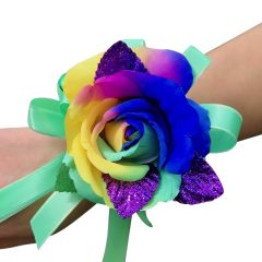 Vibrant rainbow silk corsage with purple, glitter leaves and mint green bow. 