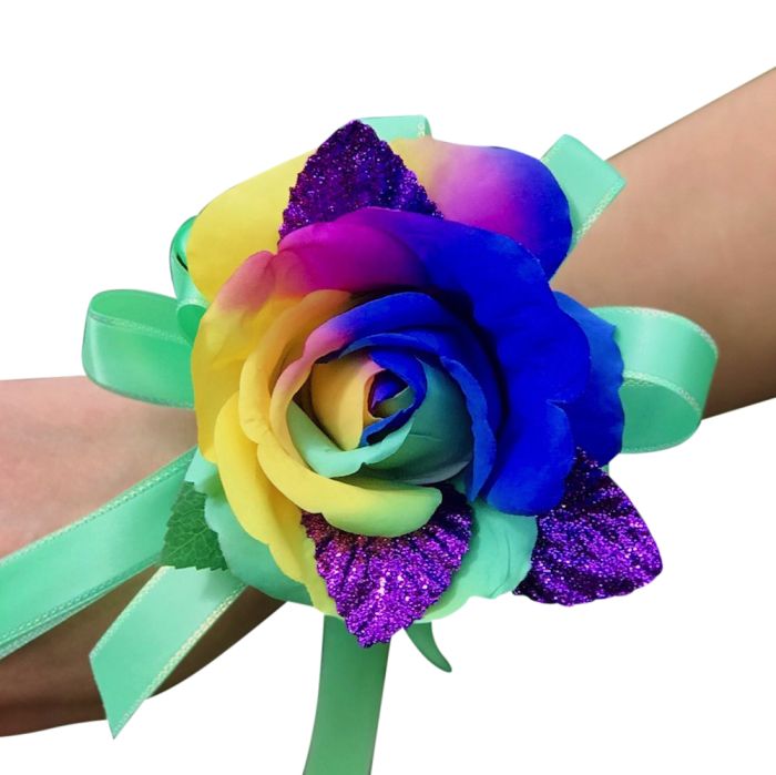 Vibrant rainbow silk corsage with purple, glitter leaves and mint green bow. 